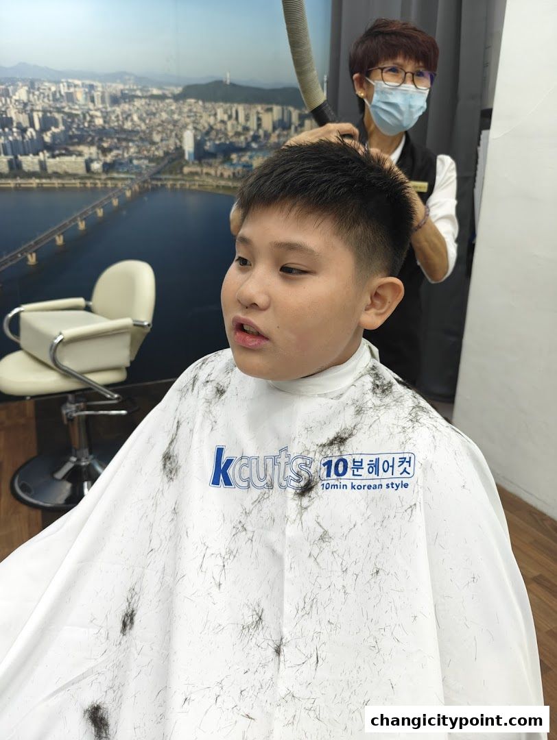 A young boy gets a haircut at Kcuts, a 10-minute Korean style salon.