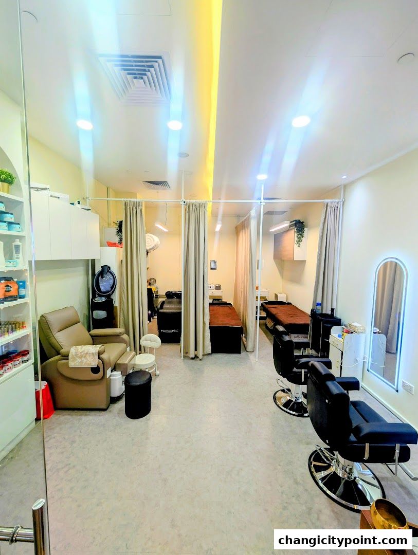 Interior view of a salon with massage beds, barber chairs, and a foot spa.