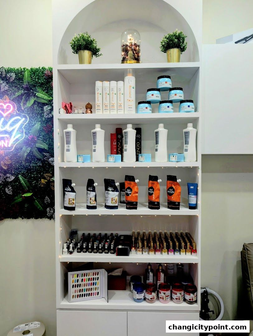 A retail display shelf filled with hair and nail care products, including bottles, jars, and nail polish.