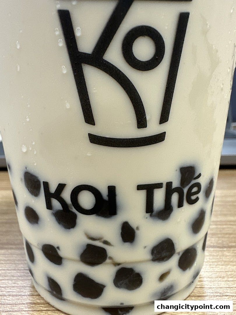 A close-up of a KOI Thé bubble tea with tapioca pearls.