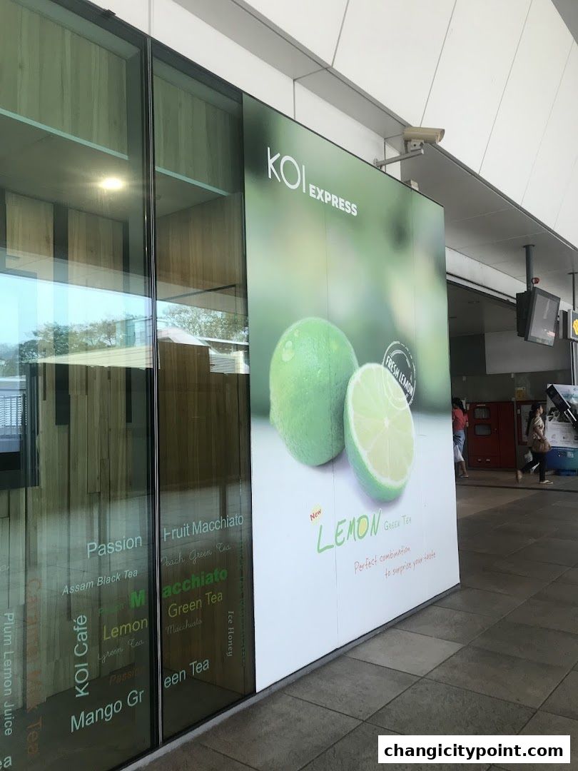 KOI Express shop front with a large advertisement for fresh lemon green tea.