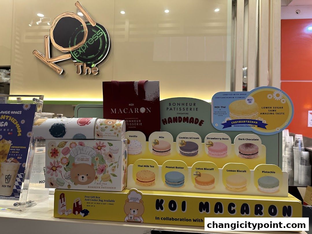 Display of KOI Express macarons and gift boxes with various flavors.