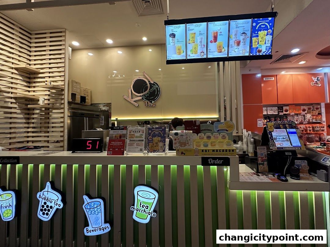 The KOI Express shop front with a digital menu board and illuminated beverage icons.