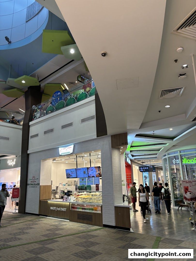 A Krispy Kreme shop with a display of donuts and a 'Made Fresh Daily' sign.