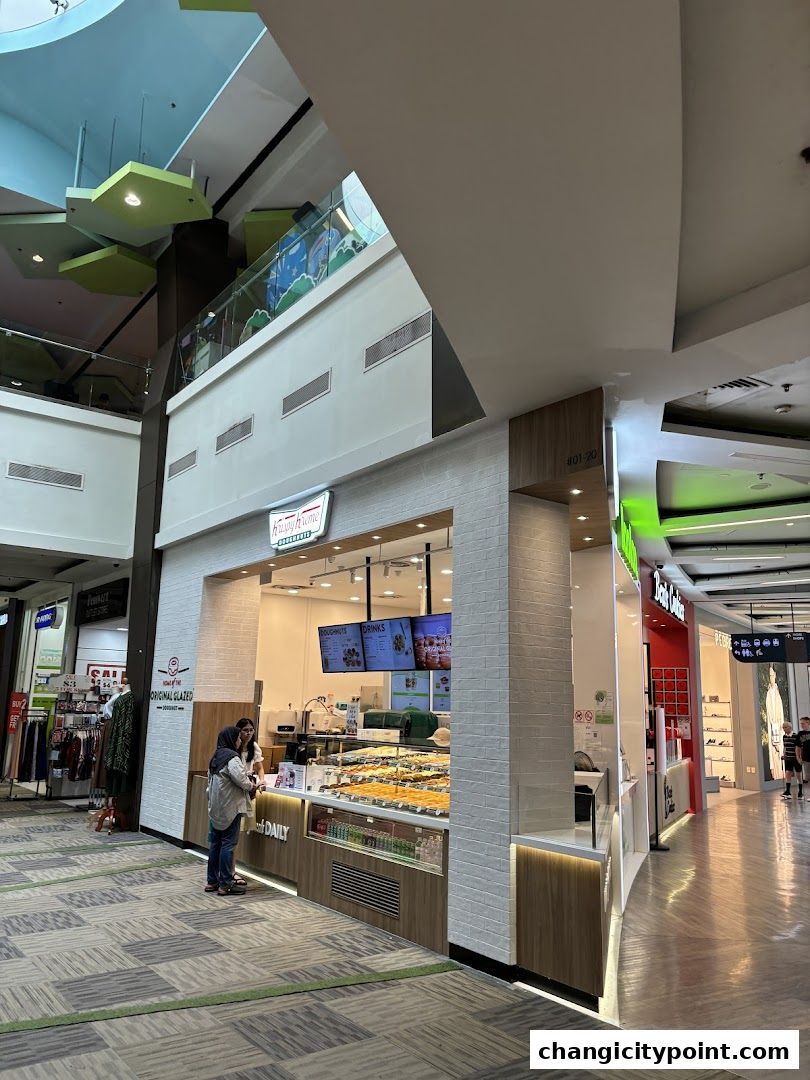 Krispy Kreme shop with a display of donuts and a menu board.