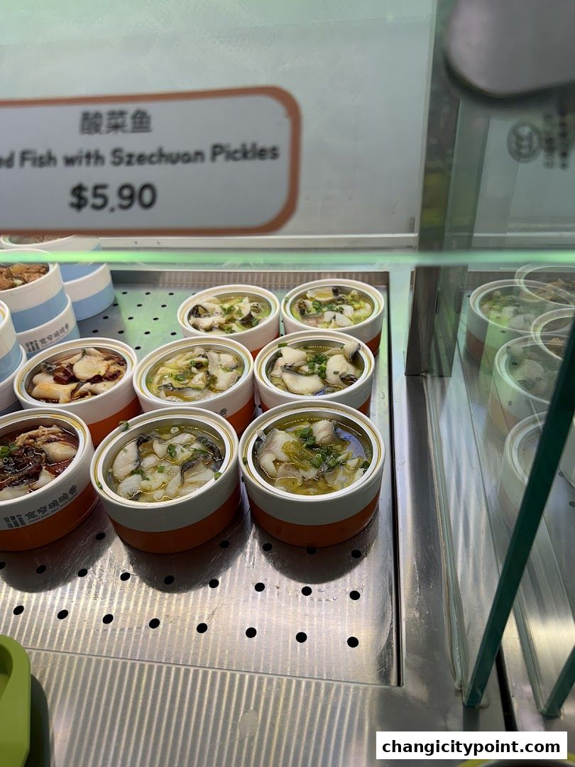 A display of pre-packaged fish dishes with Szechuan pickles.