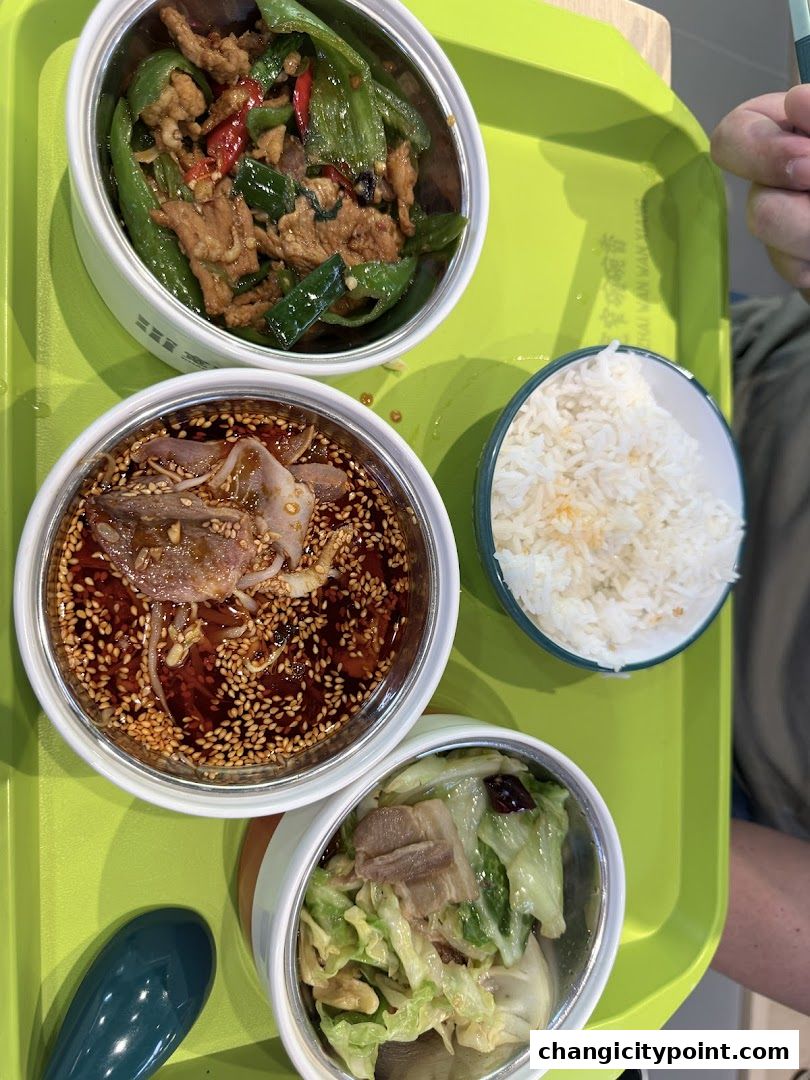 A tray with three bowls of food and a bowl of rice, ready to be served.