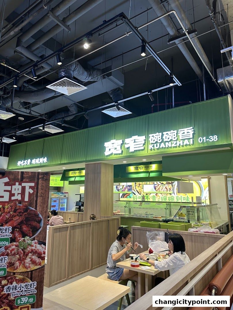Interior view of a restaurant with customers dining and a menu display.