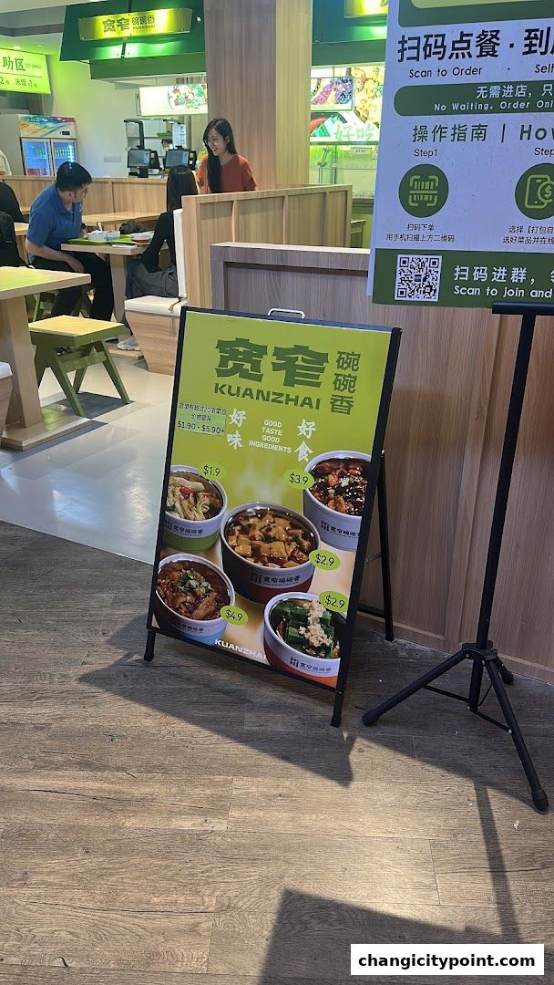 A-frame sign displays food items and prices for Kuan Zhai Wan Wan Xiang restaurant.