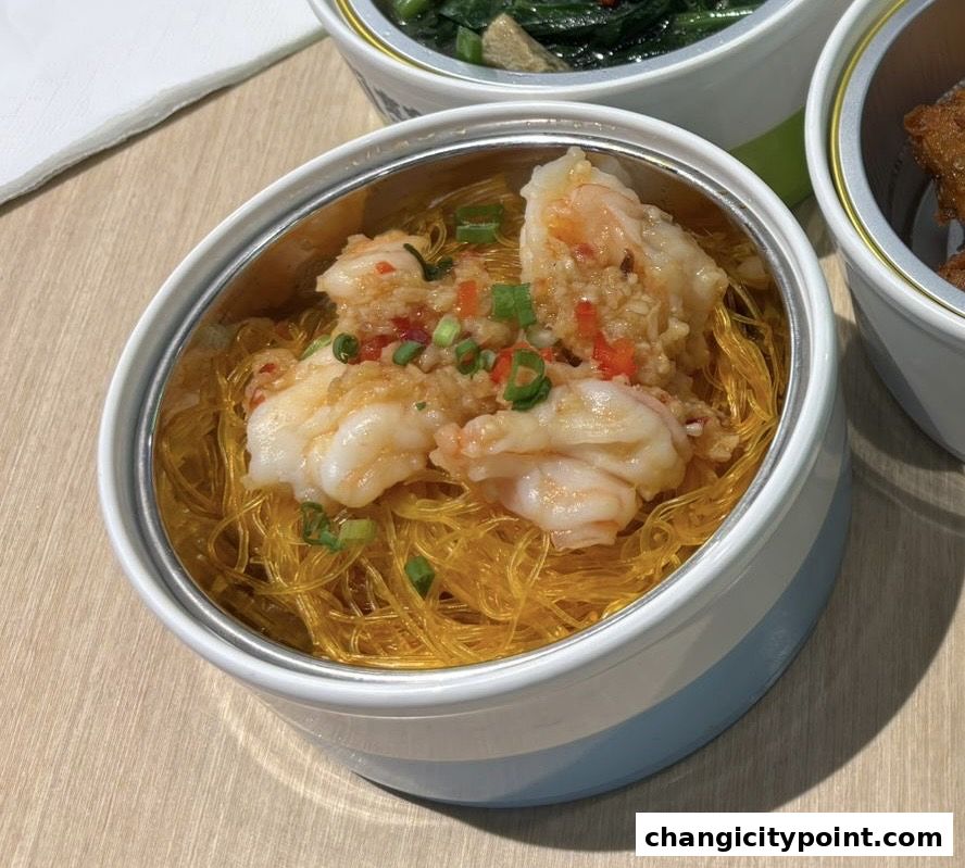 A close-up of a delicious dish featuring shrimp and noodles in a modern serving bowl.