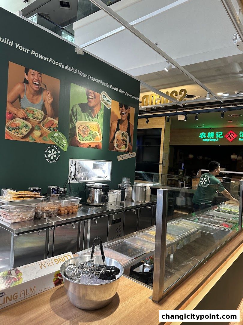 A food stall with a display of ingredients and a staff member preparing food.