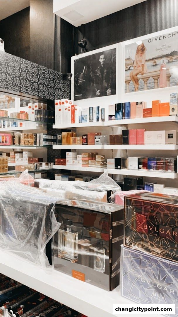 A retail shop interior displaying a wide selection of perfumes and gift sets on shelves.
