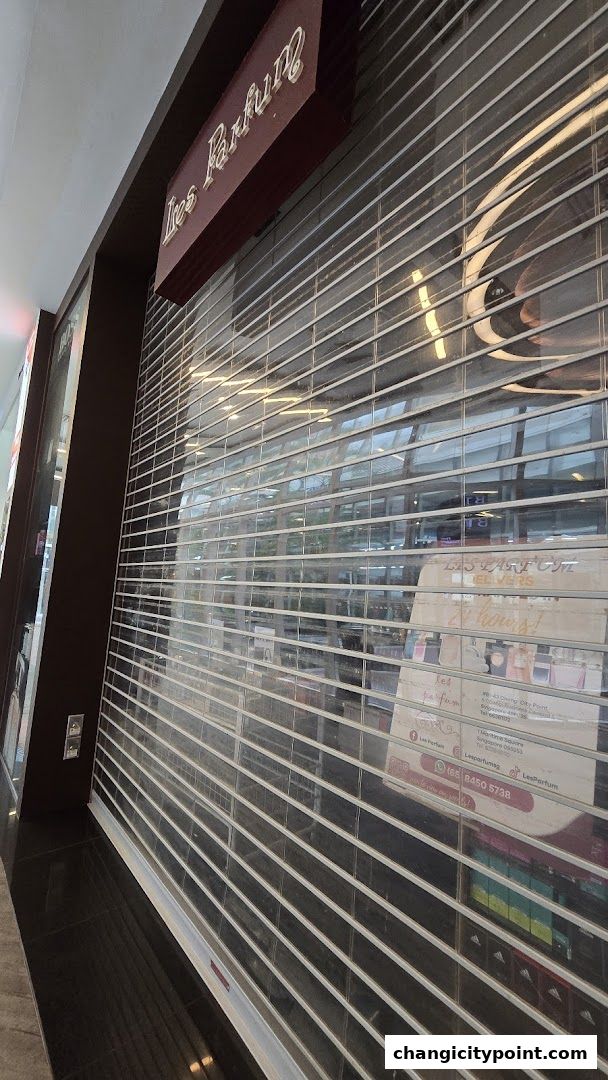 The closed storefront of Les Parfum, a perfume shop, with its sign visible.