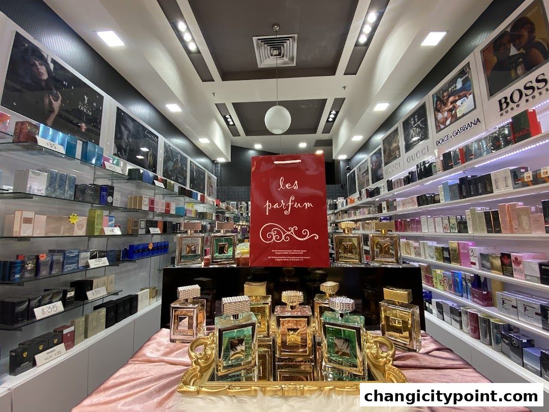 Interior view of a perfume shop with shelves stocked with fragrances and display bottles.