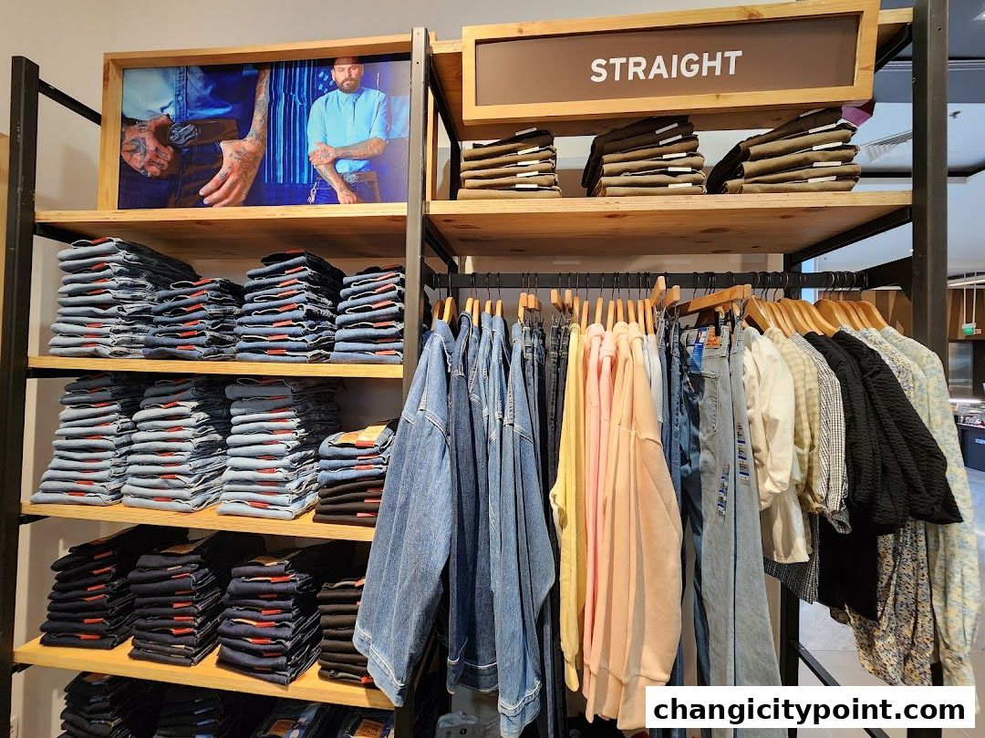 Neatly folded jeans and hanging apparel displayed in a Levi's outlet store.