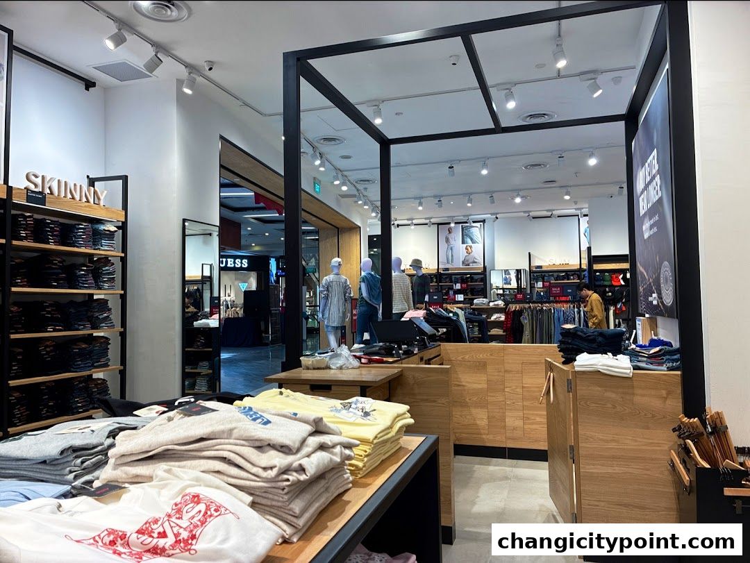 Interior view of a Levi's Outlet store showcasing folded t-shirts and stacked jeans.