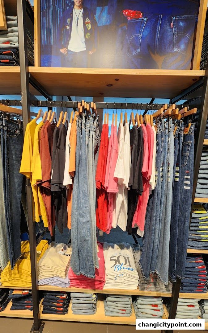 A display of colorful t-shirts and denim jeans at a Levi's outlet store.