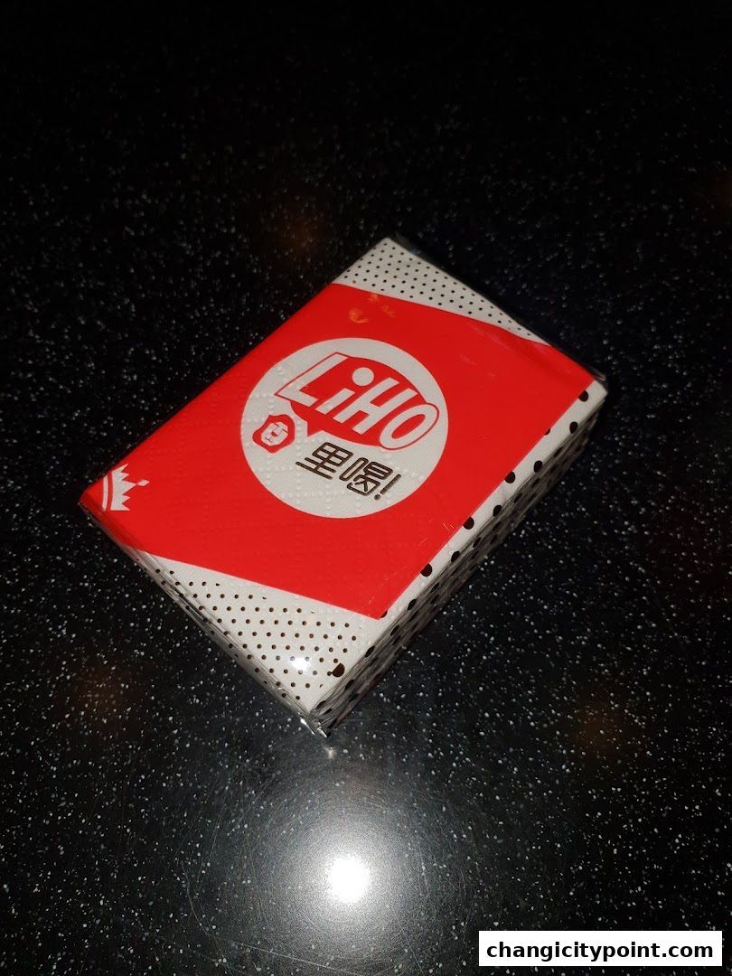 A close-up of a LiHO TEA branded box with red and white packaging.