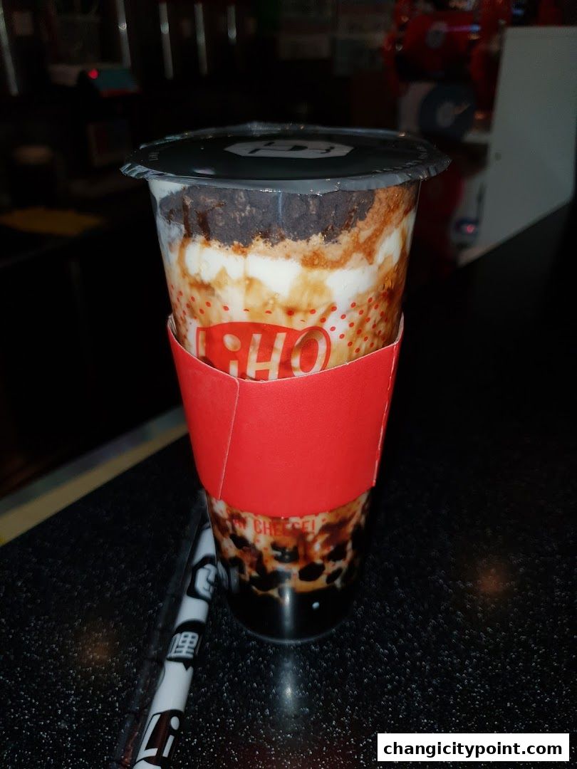 A delicious LiHO TEA beverage with creamy layers and boba pearls.