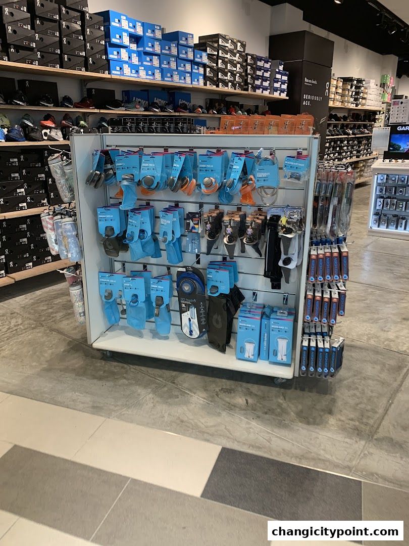 Display of hydration packs, water bottles, and running accessories in a retail store.