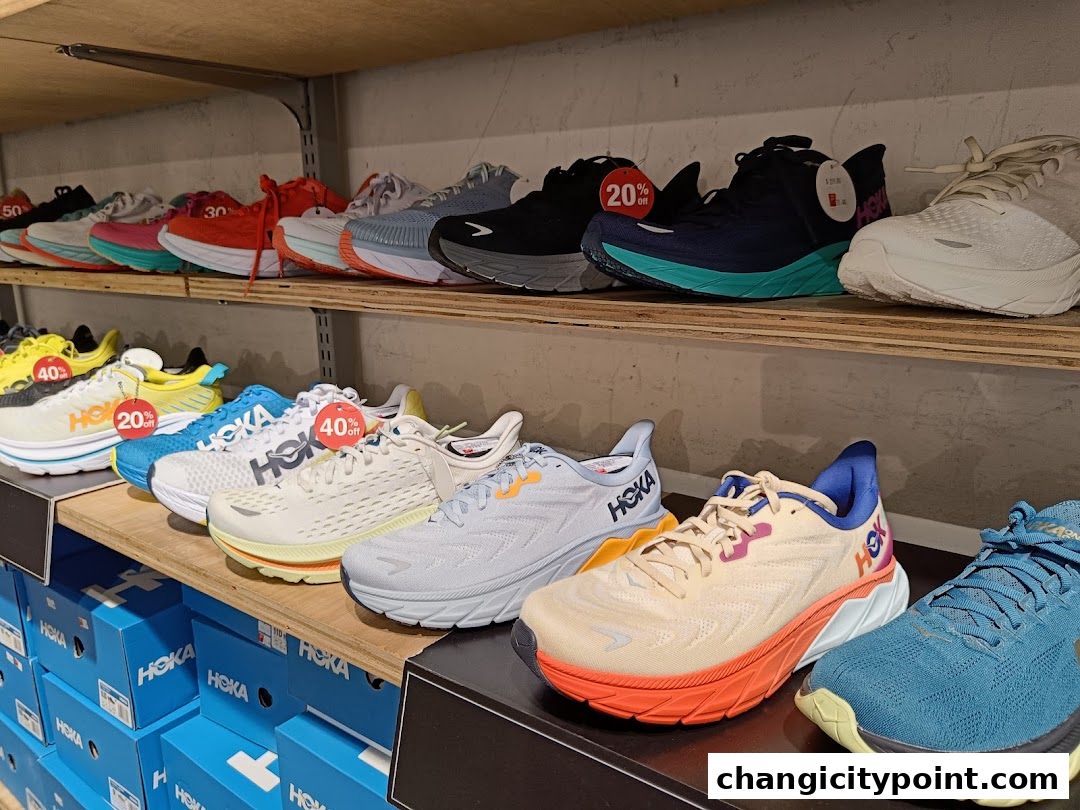 Shelves filled with various Hoka running shoes, some with discount tags.