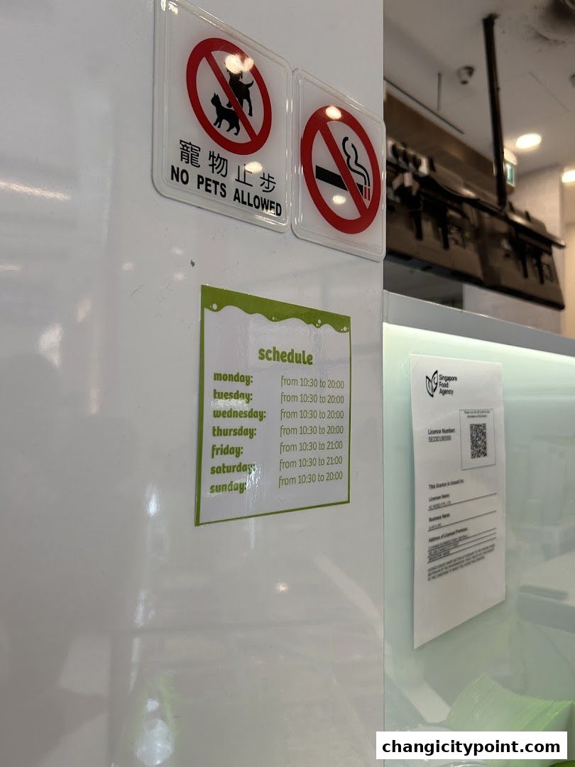Shop signs indicating no pets and no smoking, along with operating hours.