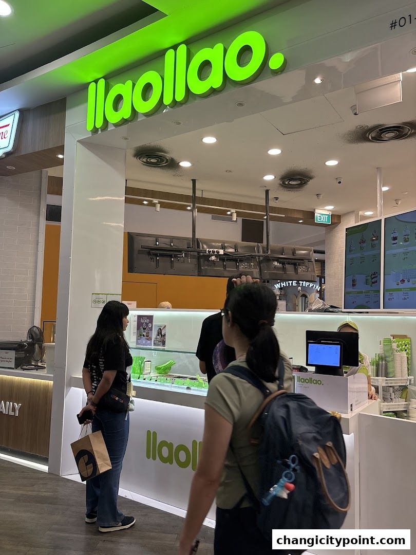 A llaollao frozen yogurt shop with customers ordering at the counter.