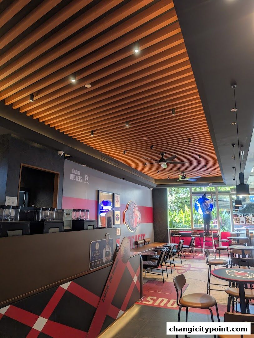 Interior of a Luckin Coffee shop with Houston Rockets branding and seating areas.