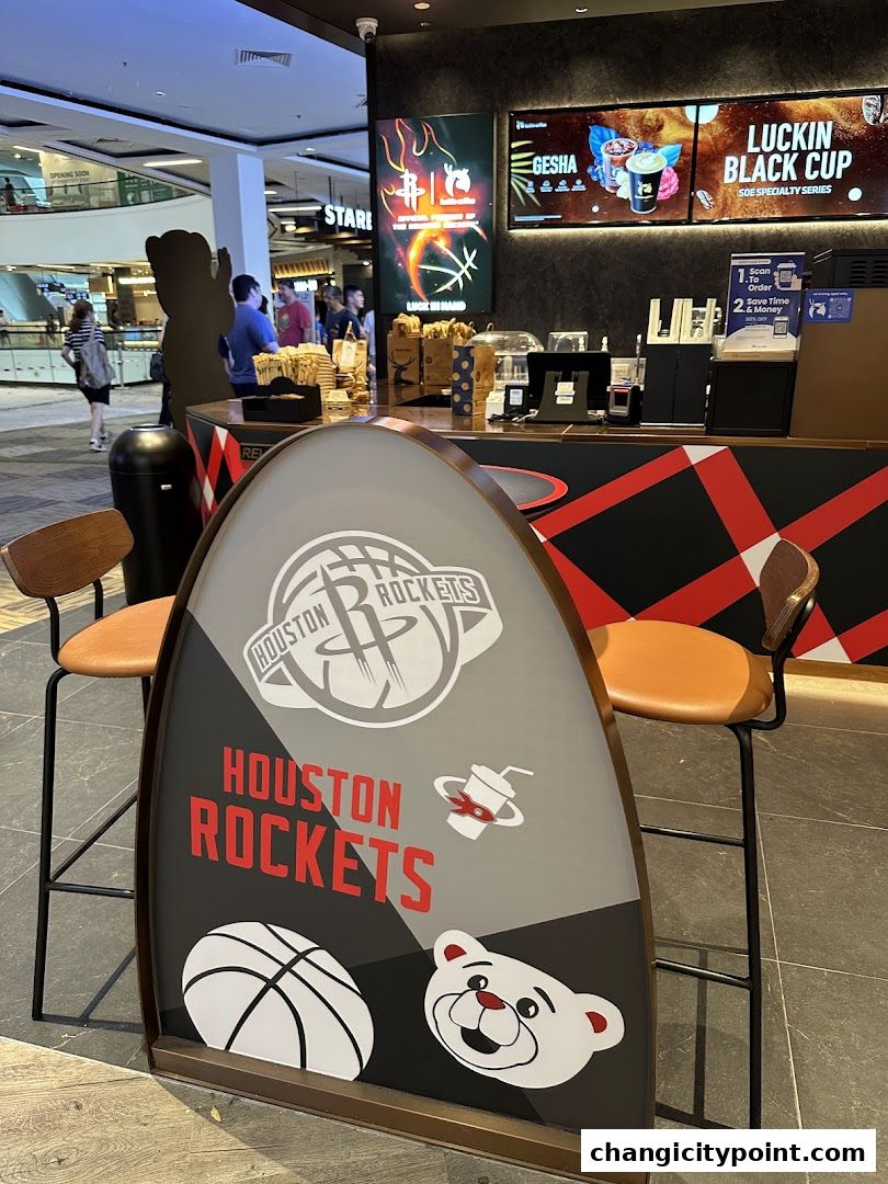 A Luckin Coffee counter with Houston Rockets branding and digital menu boards.