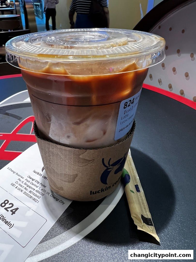 A refreshing iced latte from Luckin Coffee with a straw and receipt.