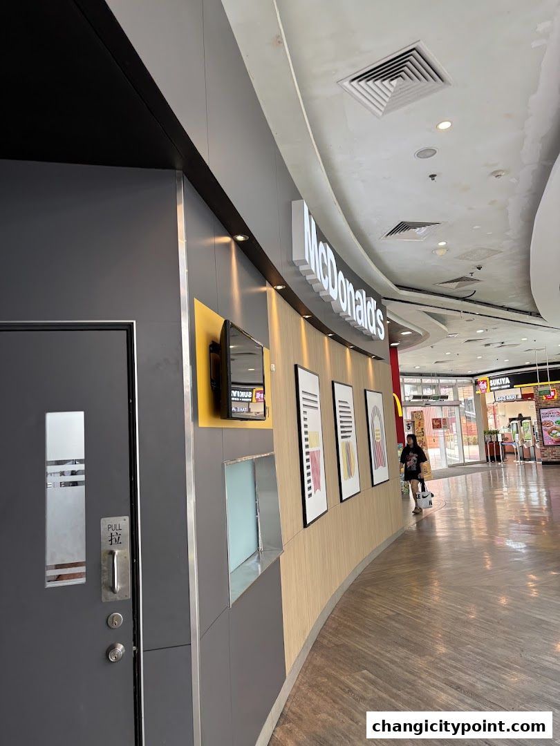 Exterior view of a McDonald's restaurant entrance with its iconic signage.