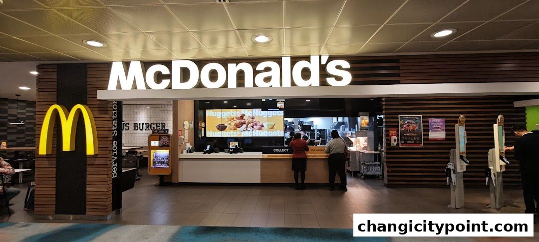 The exterior of a McDonald's restaurant with a prominent golden arch logo and signage.