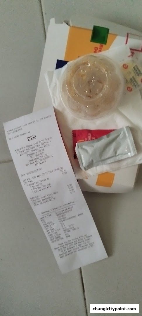 A receipt and food items from McDonald's Changi City Point.