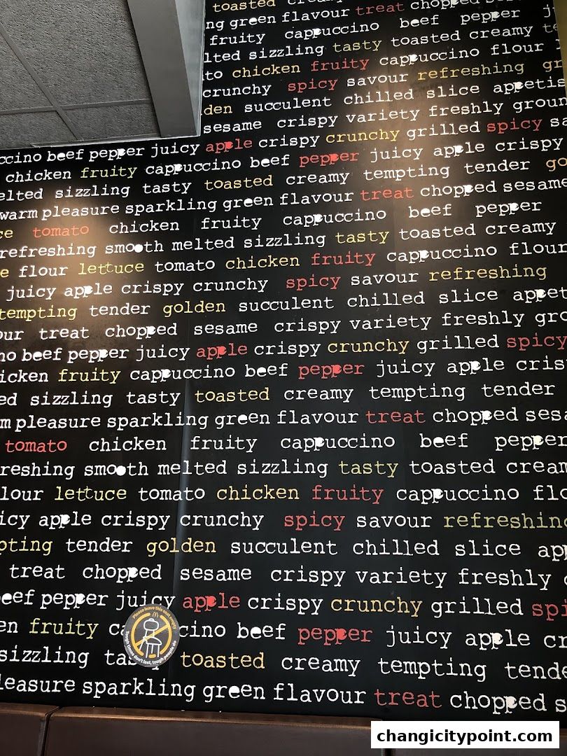 A wall with repeating words like 'spicy', 'juicy', and 'treat' in various colors.