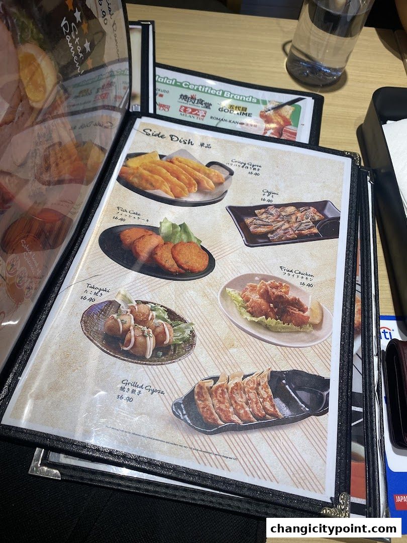 A menu featuring various Japanese side dishes like gyoza, takoyaki, and fried chicken.