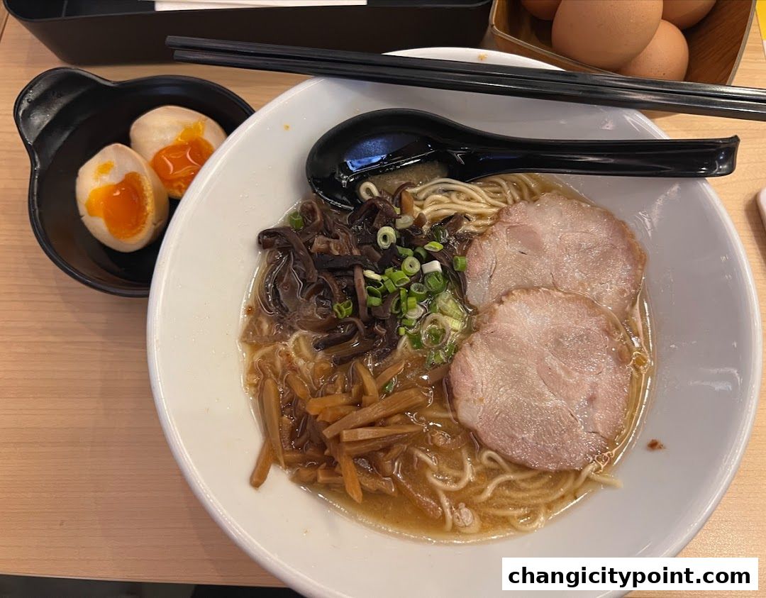 A delicious bowl of ramen with chashu pork, egg, and toppings, served with chopsticks.