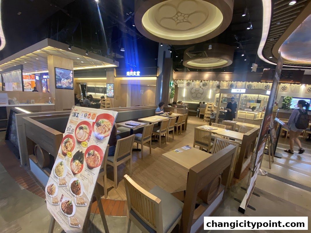 Interior view of Menzo Butao restaurant with seating and a menu stand.
