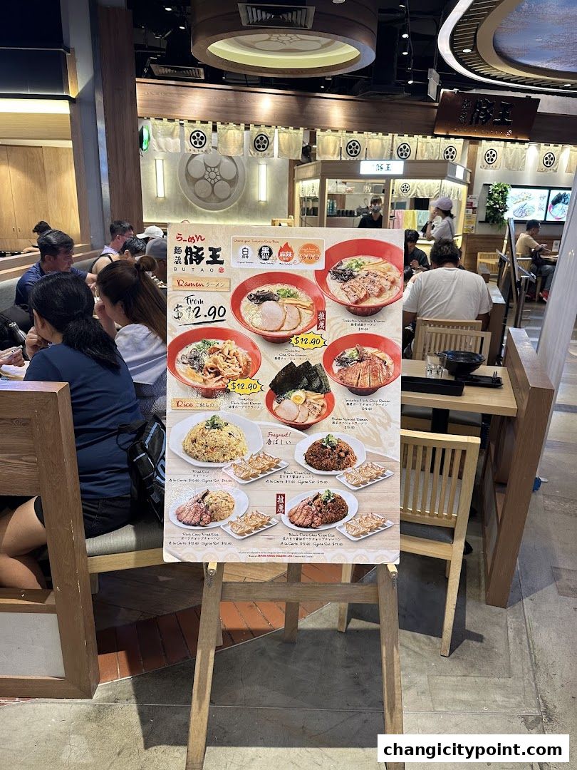A menu board displays various ramen and rice dishes from Menzo Butao.
