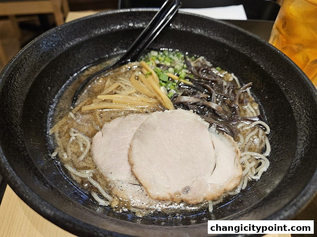 A close-up shot of a delicious bowl of ramen with chashu pork and other toppings.