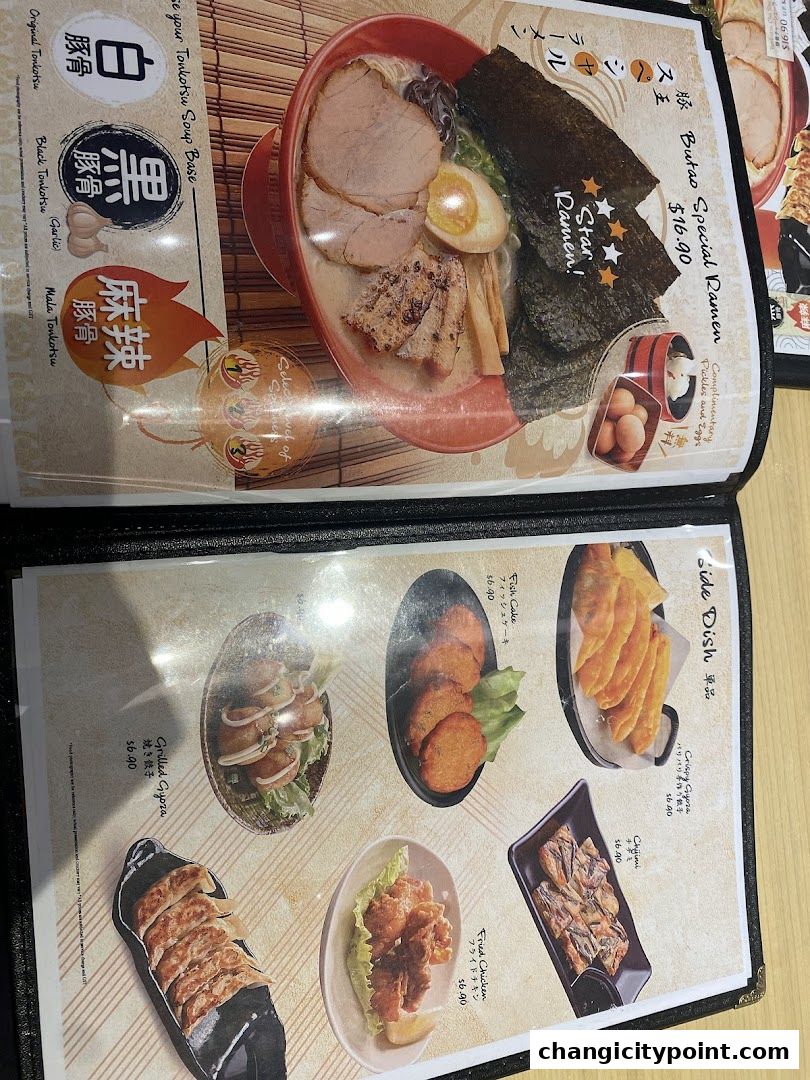 A menu featuring ramen, side dishes like gyoza, fish cake, and fried chicken.