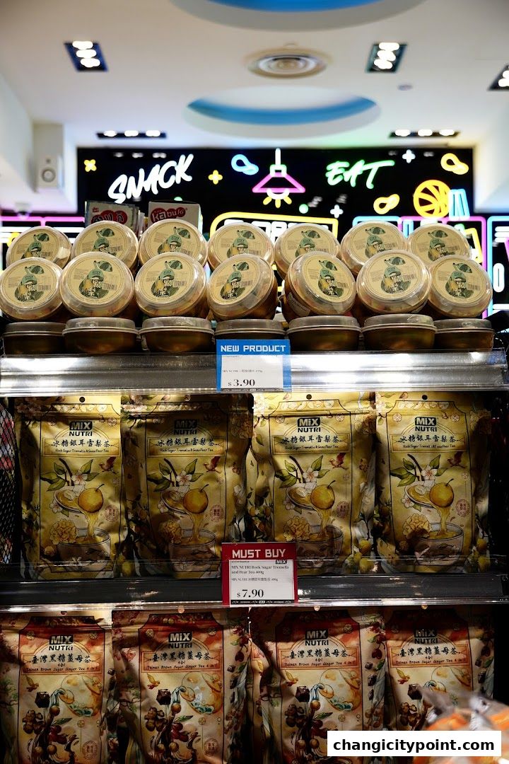 Shelves stocked with various tea products and snacks at MiX Store.