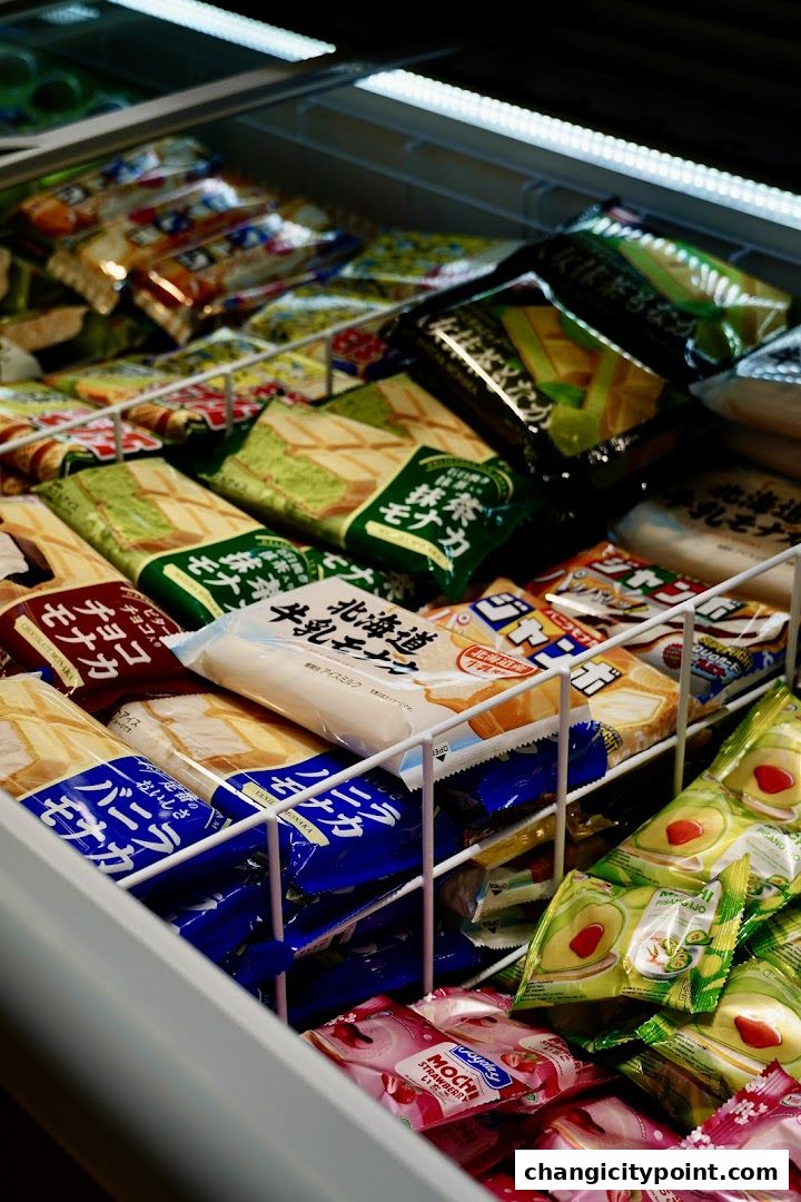 A freezer stocked with a variety of individually wrapped ice cream bars and mochi.