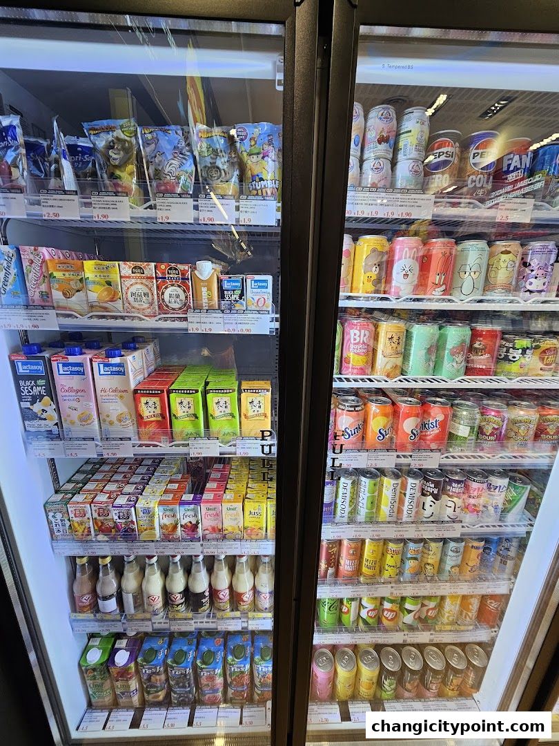 Refrigerated display cases filled with various beverages and packaged snacks.
