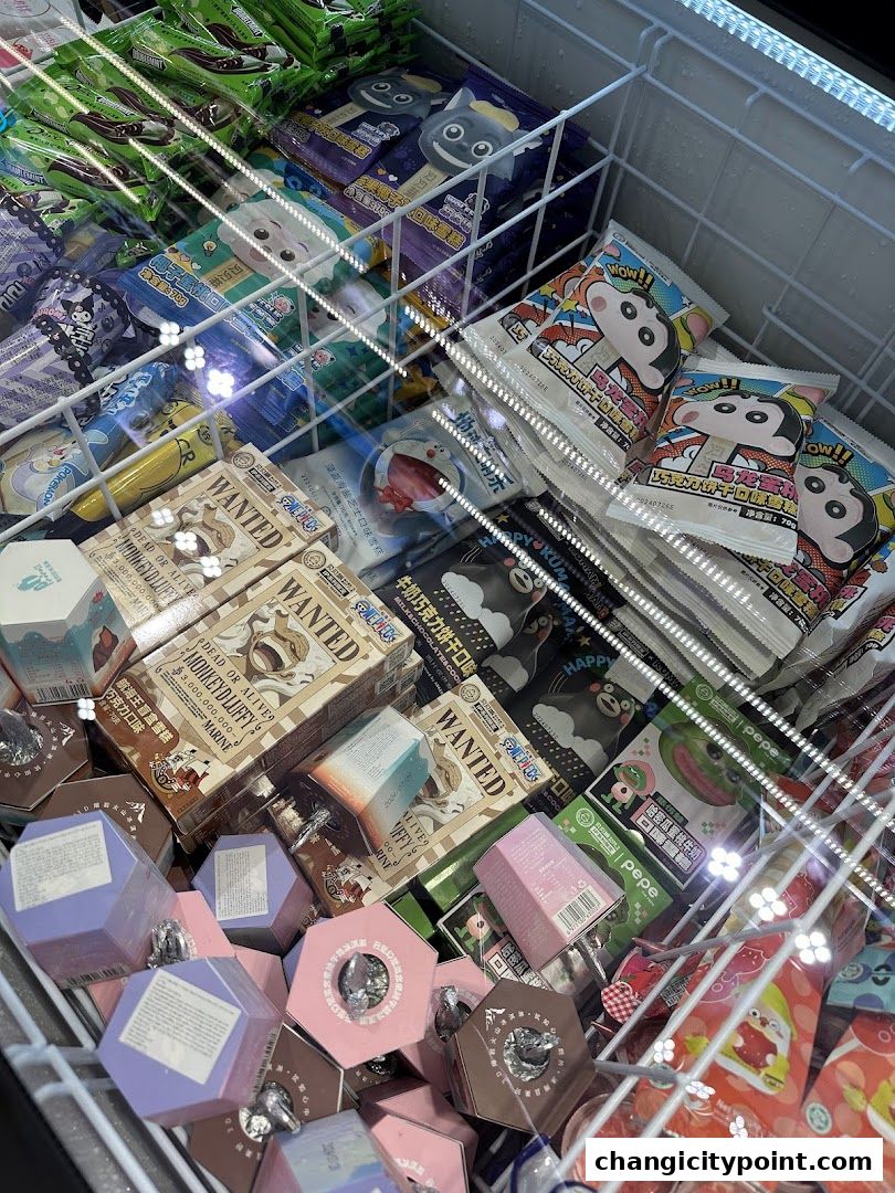 A freezer display filled with various packaged ice cream and snacks featuring cartoon characters.