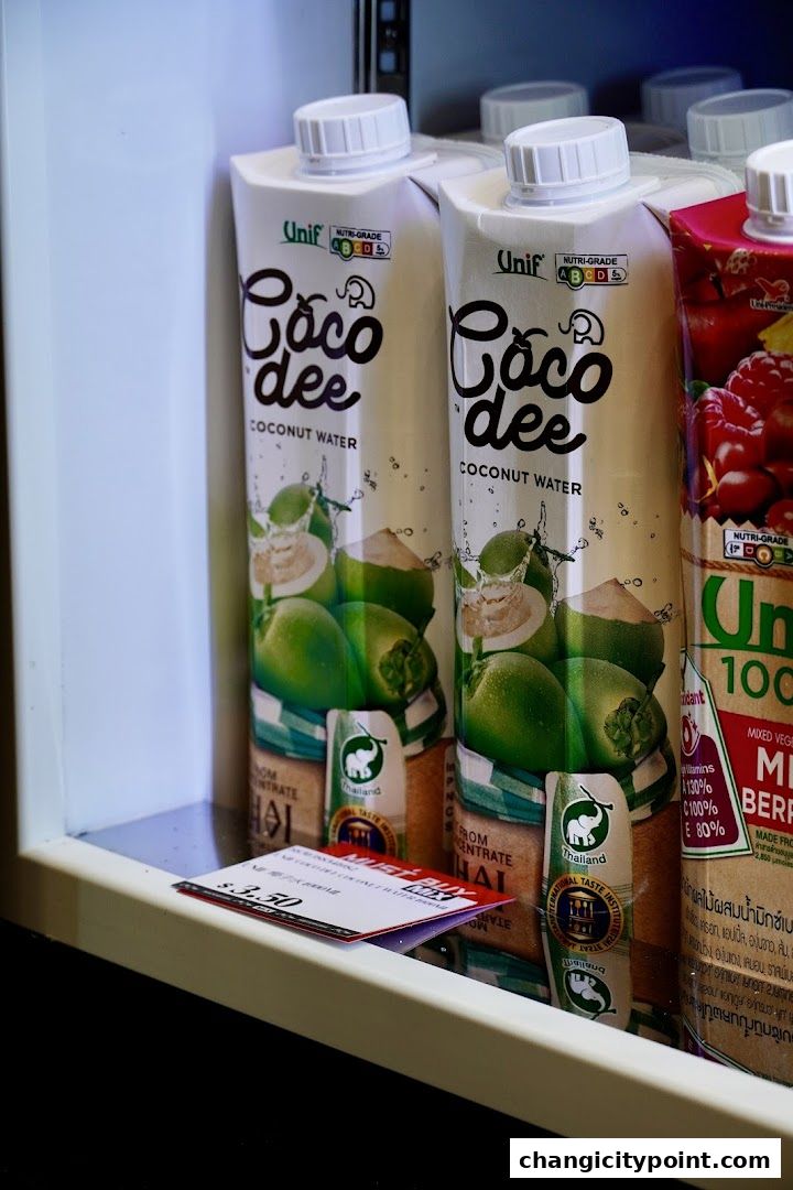 A close-up of coconut water and mixed berry drinks in a cooler.