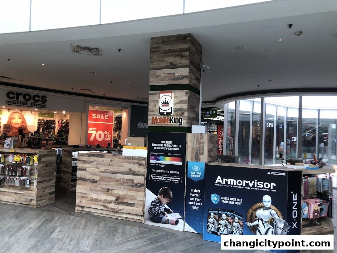 Mobile King shop front with displays of phone accessories and a sale banner.