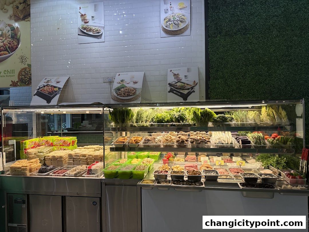 A display case filled with fresh ingredients for hotpot and grilled fish.