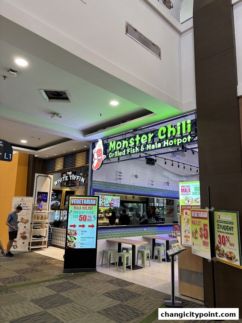 Exterior of Monster Chili Grilled Fish and Mala Hotpot with promotional signs.