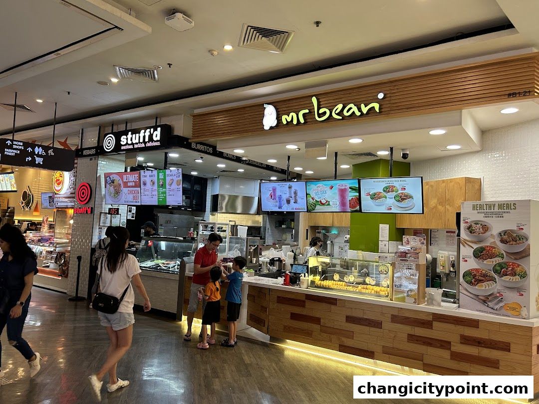 The Mr Bean shop front with a display of food and drinks, and customers ordering.