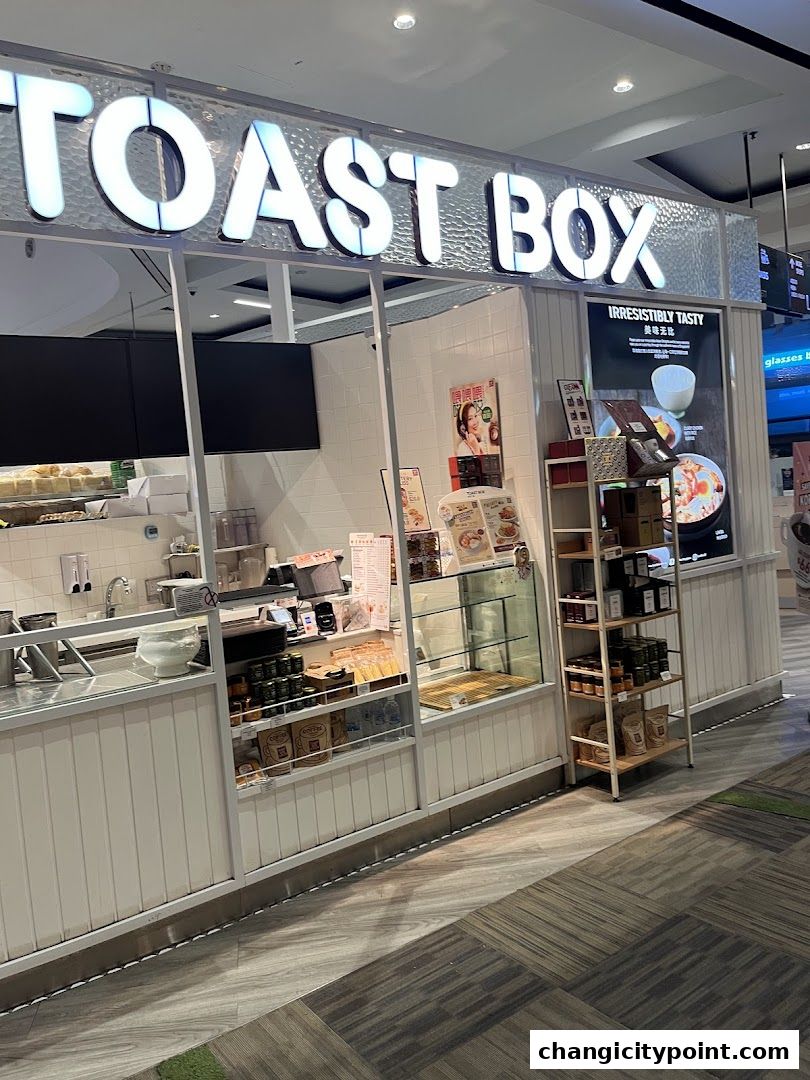 The exterior of a Toast Box shop with its prominent signage and display of products.